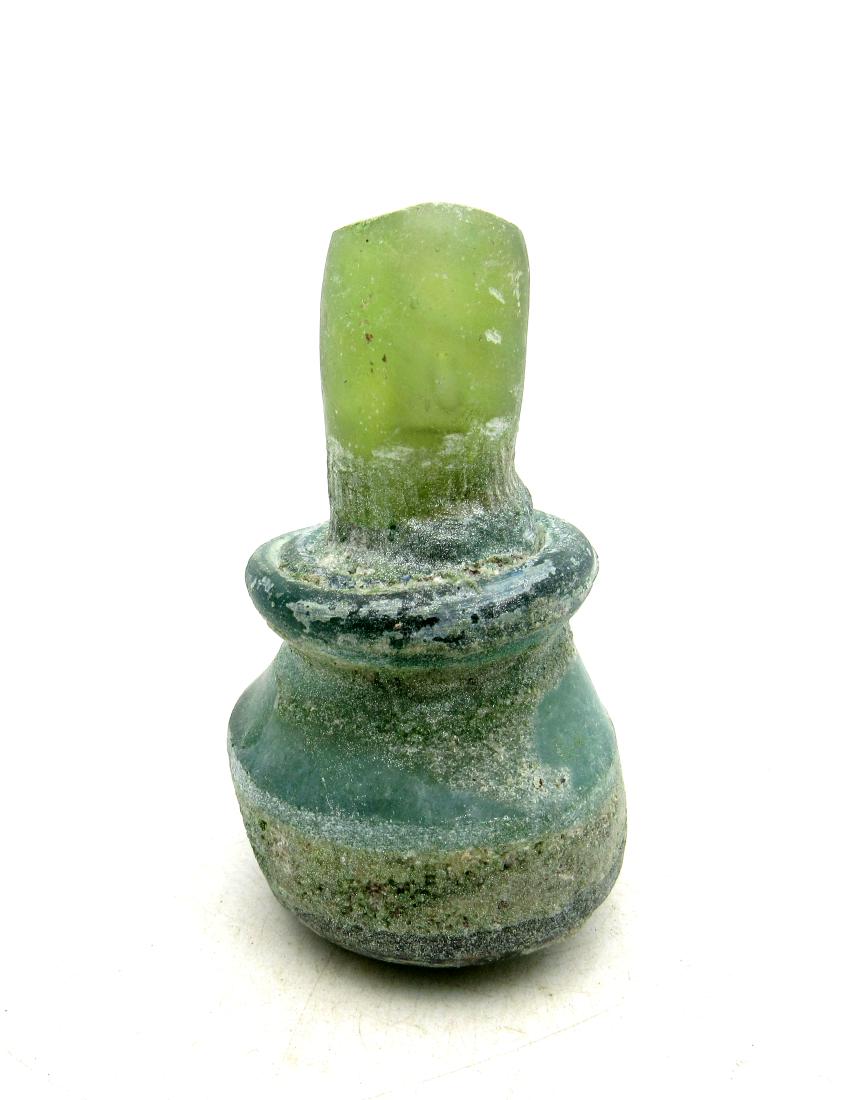 Ancient Roman Glass Flask -re: Item: Ancient Roman Glass Flask -re Date: ca. 100 - 300 AD Whilst the ancient Egyptians and Phoenicians developed coloured glass, mainly for inlays, beads, etc., it was the Romans who perfected the de