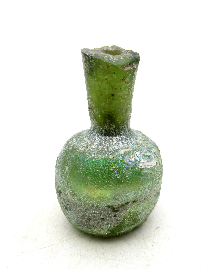 Ancient Roman Glass Flask -re: Item: Ancient Roman Glass Flask -re Date: ca. 100 - 300 AD Whilst the ancient Egyptians and Phoenicians developed coloured glass, mainly for inlays, beads, etc., it was the Romans who perfected the de