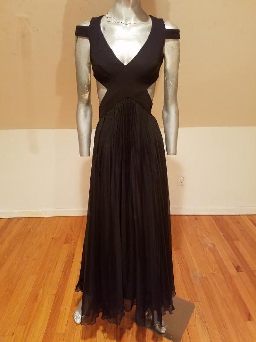 Mignon Beauty Cutout strappy gathered pleated gown: A beauty by Mignon. Black voile chiffon pencil gathered pleated skirt , strappy sensual bodice details at front V and back . A size xs . Truly a beauty Please note that this lot has a confidential res