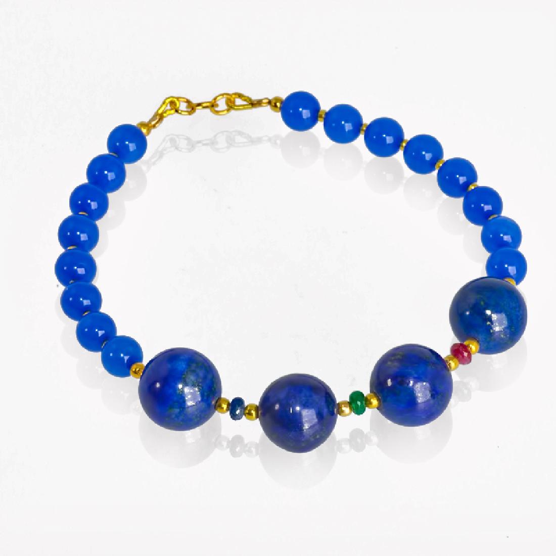 Blue Bracelet with Sapphire, Emerald and Ruby: Item: Blue Bracelet with Sapphire, Emerald and Ruby Brand: Regenz Metal Purity: .585 Yellow Gold Gemstones: Lapis lazuli, Onyx, Sapphire, Ruby, Emerald Size/Dimensions: External length (incl.clasp) ~8