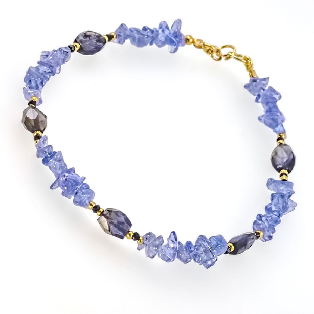 Tanzanite Bracelet with Sapphires: Item: Tanzanite Bracelet with Sapphires Brand: Regenz Metal Purity: .585 Yellow Gold Gemstones: Tanzanite, Sapphire, Iolite Size/Dimensions: External length (inc. clasp) ~ 8.25" (21 cm) Tanzanite irre