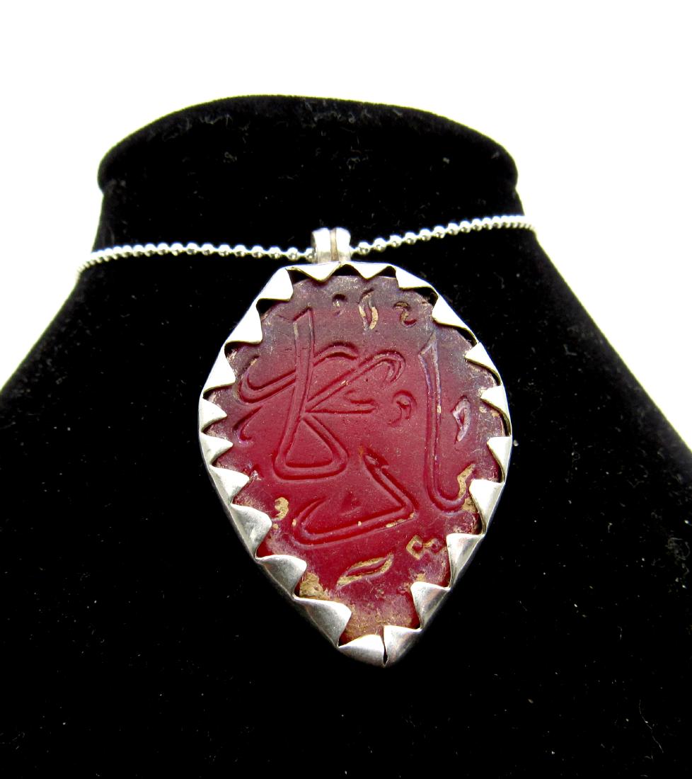 Medieval Crusaders Era Islamic Inscribed Carnelian &: Item: Medieval Crusaders Era Islamic Inscribed Carnelian & Silver Pendant Date: C. 1200 - 1400 A.D. Material: carnelian, silver Dimensions: 37mm; 11.6grams Provenance: Obtained from an old British col