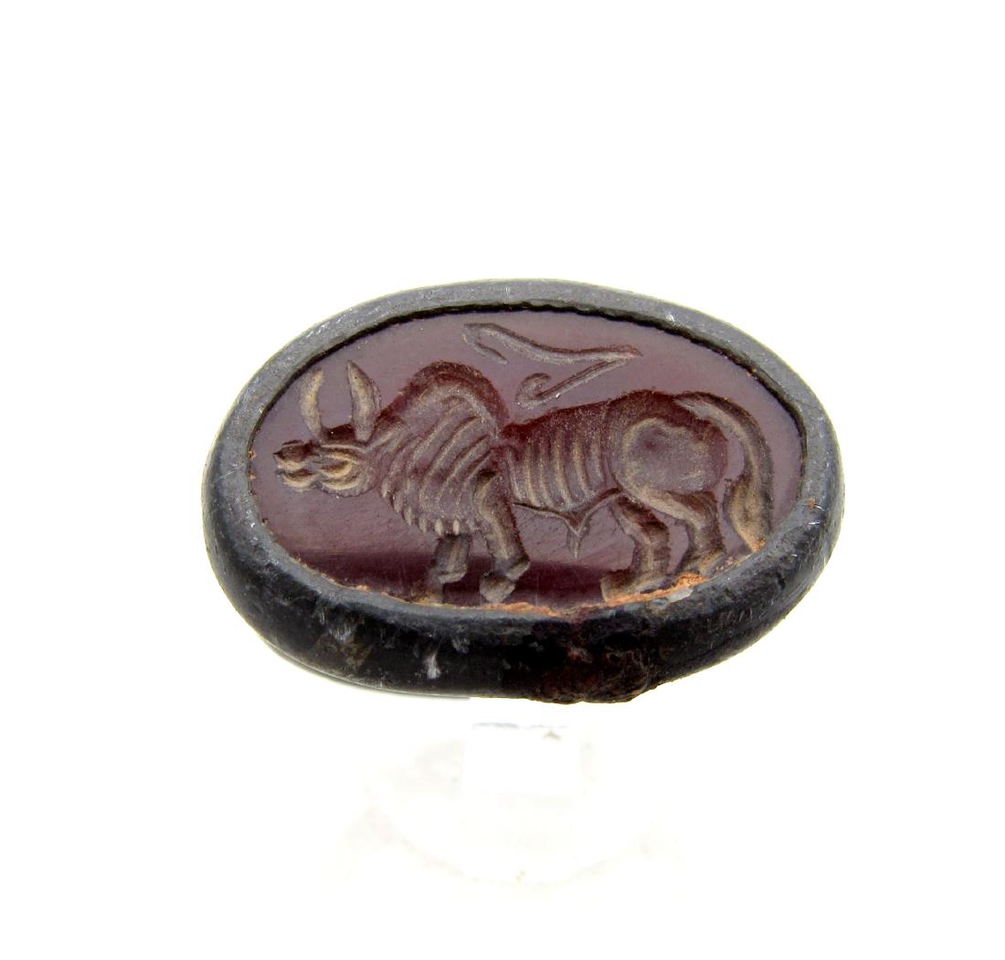 Ancient Carnelian Intaglio Bull Set in Modern Ring: Item: Ancient Carnelian Intaglio Bull Set in Modern Ring Date: 15thC - 18th C AD Material: carnelian, bronze Dimensions: 19mm; 6grams Provenance: Obtained from an old British collection, purchased fro