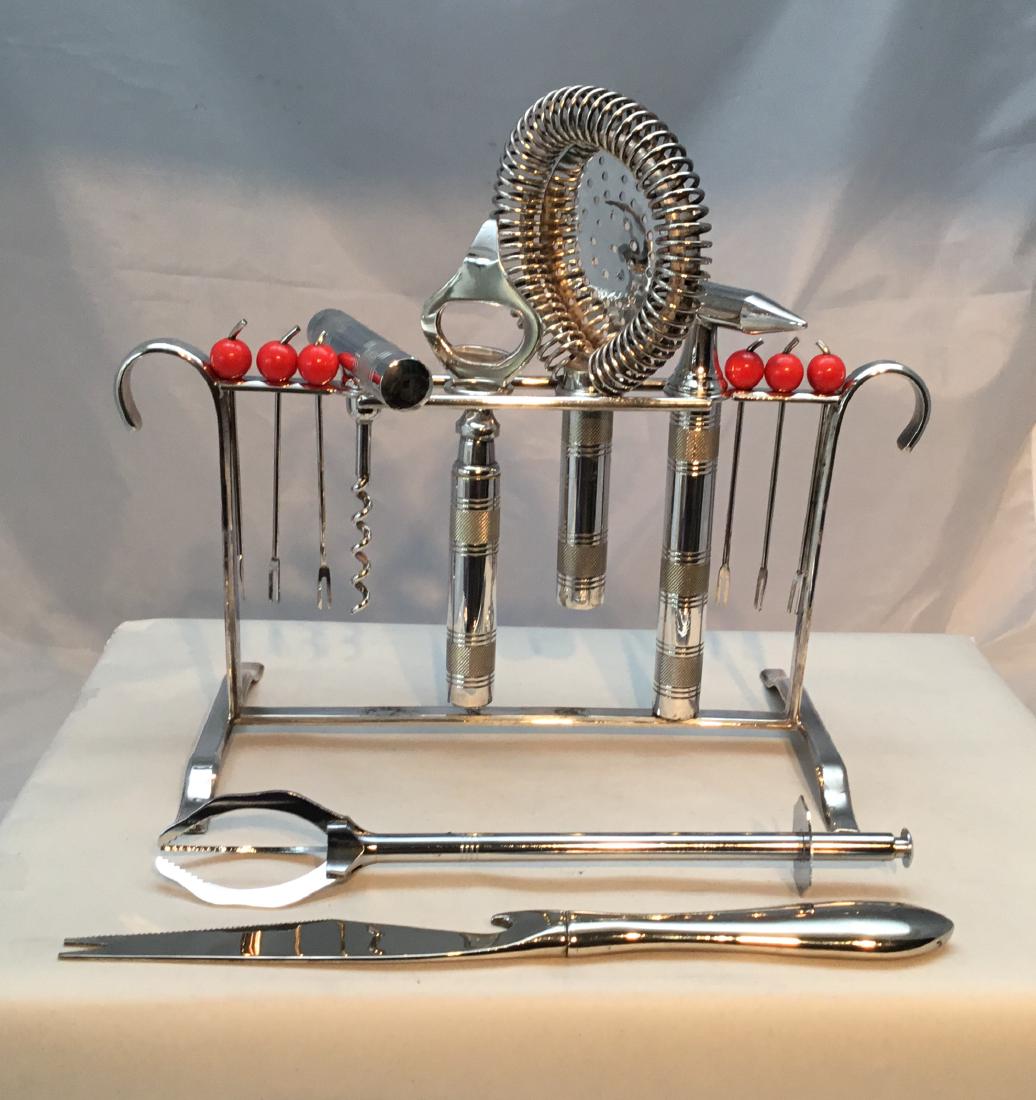 Silverplate Stand with Bar Tools and Accessories: Title: Silverplate Stand with Bar Tools and AccessoriesFrench, 1930â€™s. Dimensions: Stand is 10â€ wide and 5.25â€ high The silverplated stand has on it an Ice Hammer, Strainer, Bottle Open