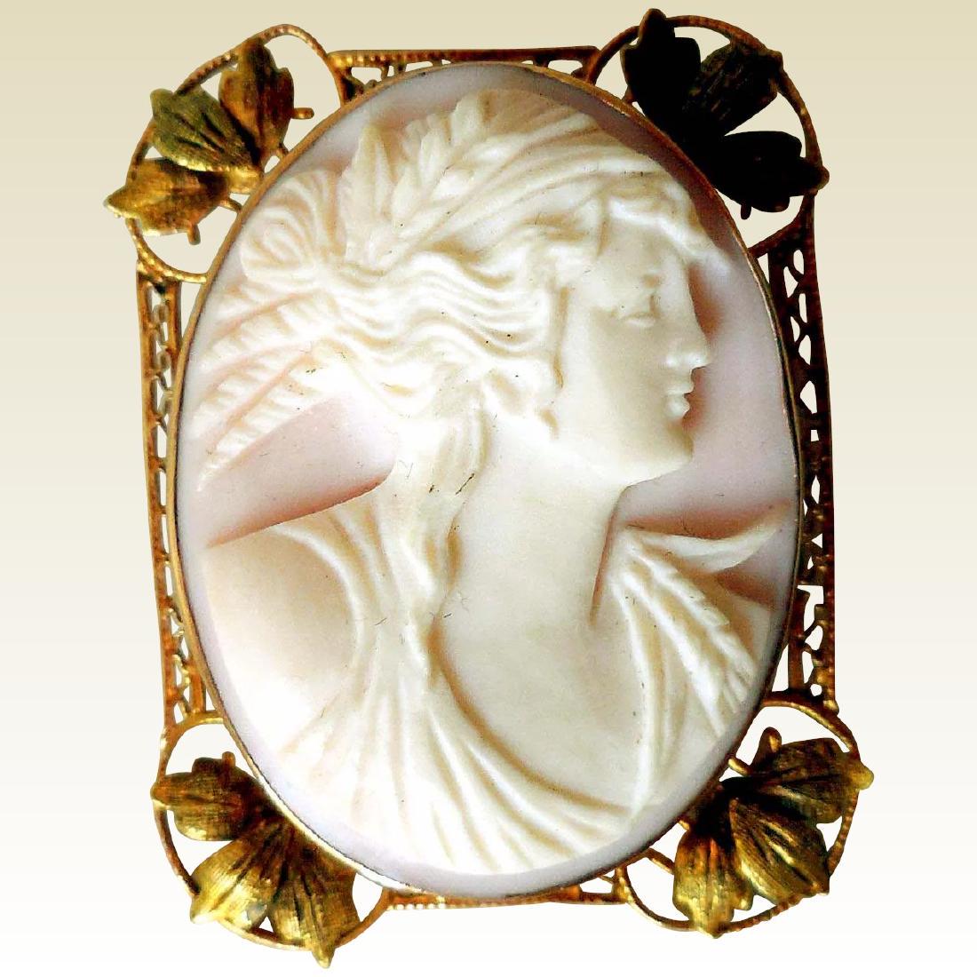 Edwardian Angel Skin Cameo in 10K Gold: Item: Edwardian Angel Skin Cameo in 10K Gold Maker: Unknown Origin: Unknown Date/Period: Ca 1900 Materials: 10K Yellow Gold, Angel Skin Coral Size: Overall 1 5/8 inches long by 1 1/4 inches wide, 1/2 