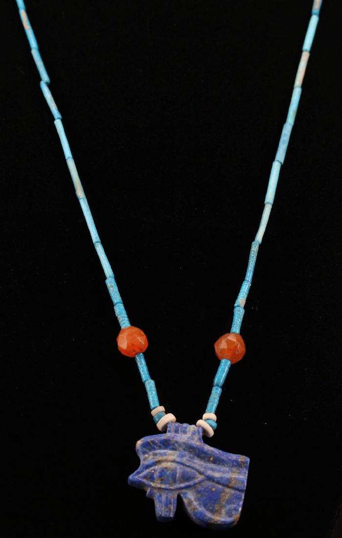 Egyptian Faience Necklace With Udjat Amulet: Item: Egyptian faience necklace with Udjat Amulet. Origin: EGYPT Date/Period: Egyptian - Middle Kingdom to Late Period, 2133-332 Materials: Stone Faience Size: 60cm Egyptian faience necklace with Udja