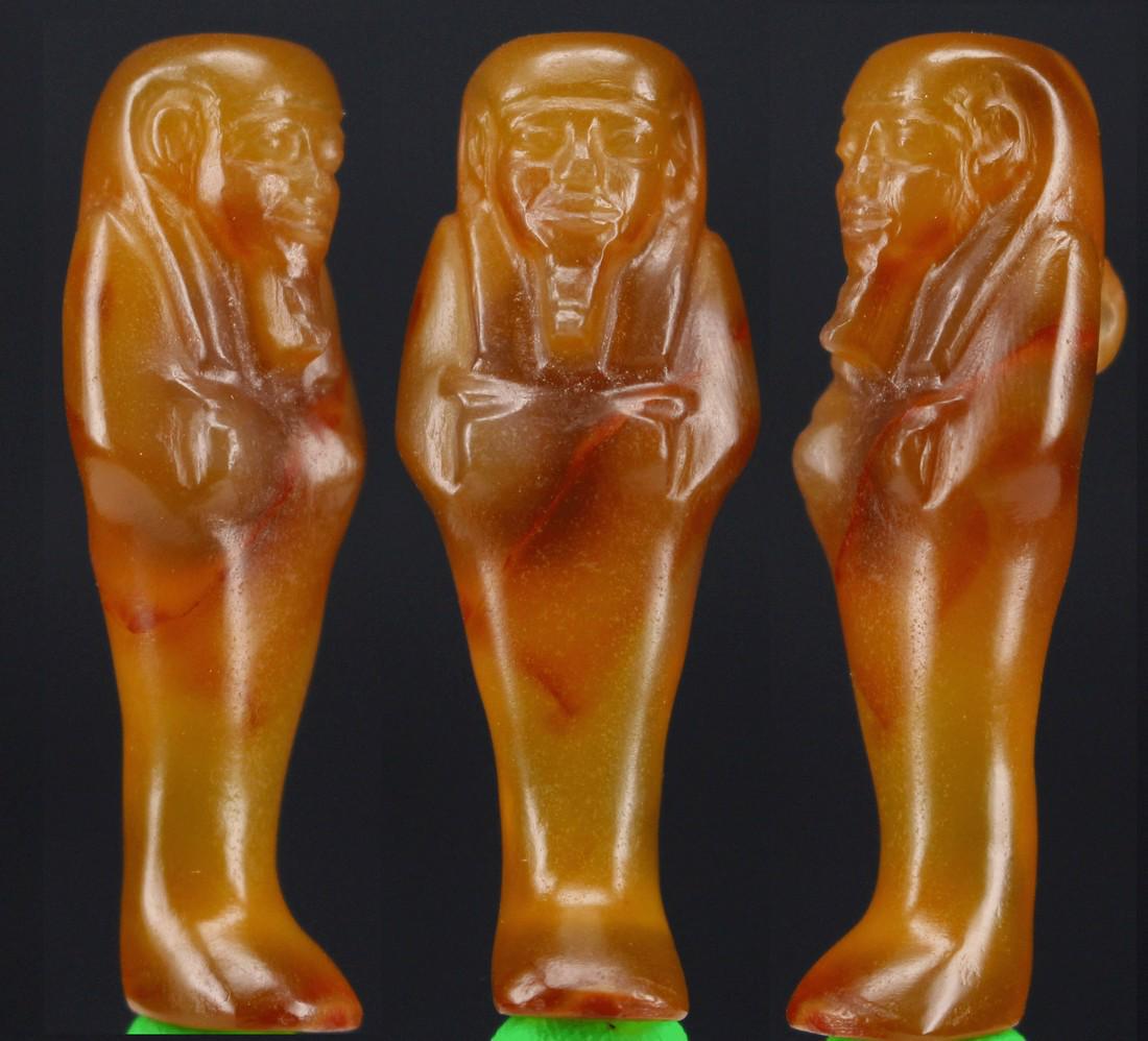 Egyptian Carnelian Shabti Amulet New Kingdom: Item: Egyptian carnelian shabti amulet New Kingdom. Origin: EGYPT Date/Period: New Kingdom, 18th-20th Dynasty, ca. 1550-1069 BCE Materials: Carnelian Size: c. 1,77 inches - ca. 4,5 cm. NEW KINGDOM CAR