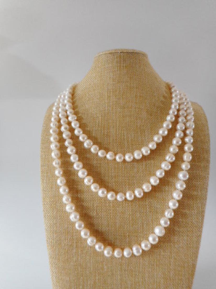 Pearl necklace of white baroque cultured freshwater: Title: Pearl necklace of white baroque cultured freshwater pearls - Style opera - 750 / 18K yellow gold clasp - 70 inch Length Date/Period: 2018 Materials: 18ct yg, cultured fresh water pearls Size: 7