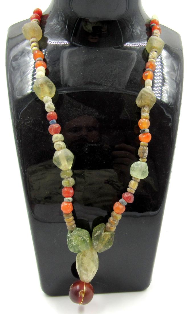 Medieval Viking Era Glass & Stone Beaded Necklace: Medieval Viking Era Glass & Stone Beaded Necklace Date: Circa 900 – 1100 AD Medieval Viking Era Glass & Stone Beaded Necklace. This item has been professionally cleaned to show original details, and