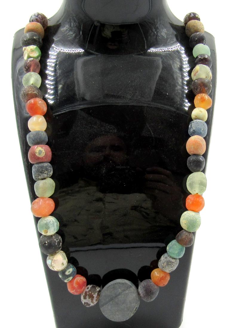 Medieval Viking Era Glass & Stone Beaded Necklace: Medieval Viking Era Glass & Stone Beaded Necklace Date: Circa 900 – 1100 AD Medieval Viking Era Glass & Stone Beaded Necklace. This item has been professionally cleaned to show original details, and
