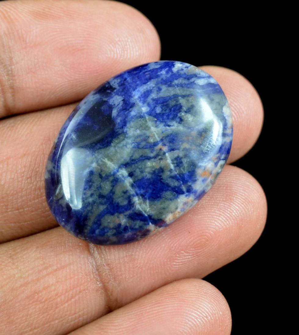 35.05 Ct Natural Untreated Blue Sodalite Namibian: Item: 35.05 Ct Natural Untreated Blue Sodalite Namibian Additional Information: Total Carat Weight (TCW): 35.05 Length: 30mm Width: 22mm Depth: 7mm Variety/Type: blue sapphire Shape: Oval Color: Blue