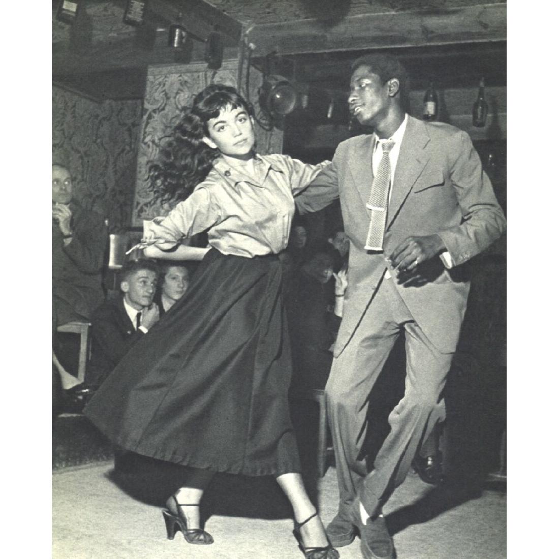 ROBERT DOISNEAU - au "Vieux Colombier": Artist: ROBERT DOISNEAU Print Title: Claude Mocquery & James Campbell au "Vieux Colombier" Medium: Sheet-fed Gravure Printing Date: 1952 Printed in France Image Size: 6.75 x 8.25 inches Robert Doisnea