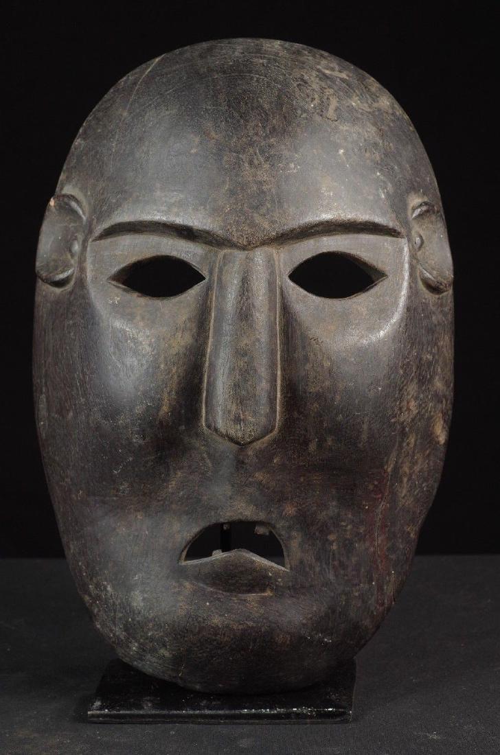 Black Atoni Mask West Timor, Indonesia: black Atoni mask - West Timor, Indonesia DIMENSIONS: cm 30 x 20 (inches: 12"x 8") WEIGHT: 0,580 kg Black mask, quite refined for a Timorese artifact, with smooth lines, has ears and teeth. Some thin c