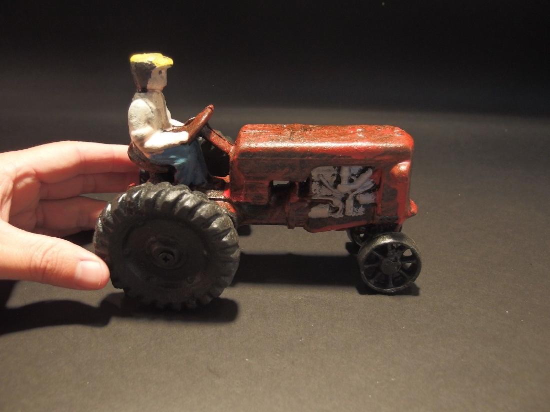 Cast Iron Red Farm Tractor Toy Car: 7" Long x 3 3/4" Wide 5" Tall 4 lbs 5 oz Such a neat reproduction cast iron tractor! As you can see this heavy cast iron tractor was hand painted and distressed to look original. Very solid! It is all
