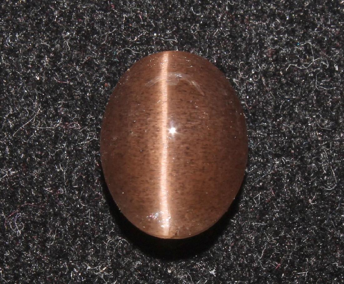 4.20 Ct Natural Scapolite Cat's-Eye: Family: Scapolite Variety: Cat's Eye Scapolite Hardness: 6 6.5 Origin: Madagascar Weight: 4.20 Ct Dimensions: 10.4x8.3x6.2 mm Shape/Cut: Oval Cabochon Colour: Reddish Brown