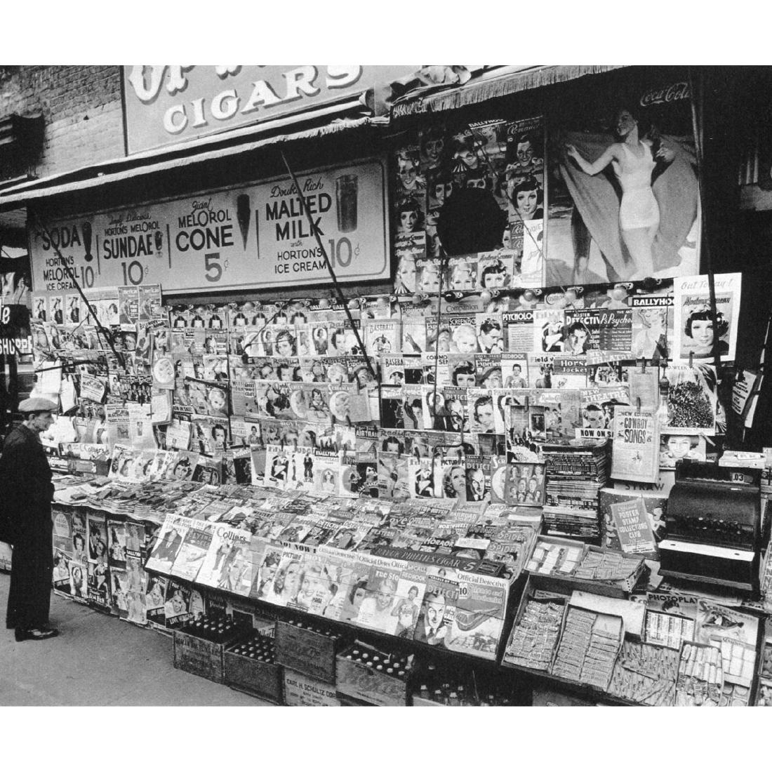 BERENICE ABBOTT - Newstand 1935: Artist: BERENICE ABBOTT Print Title: Newstand 1935 Medium: Sheet-Fed Gravure Printed in 1970's Printed in Switzerland Image size approx. 8.5 X 7 inches Berenice Alice Abbott(1989-1991) was an American