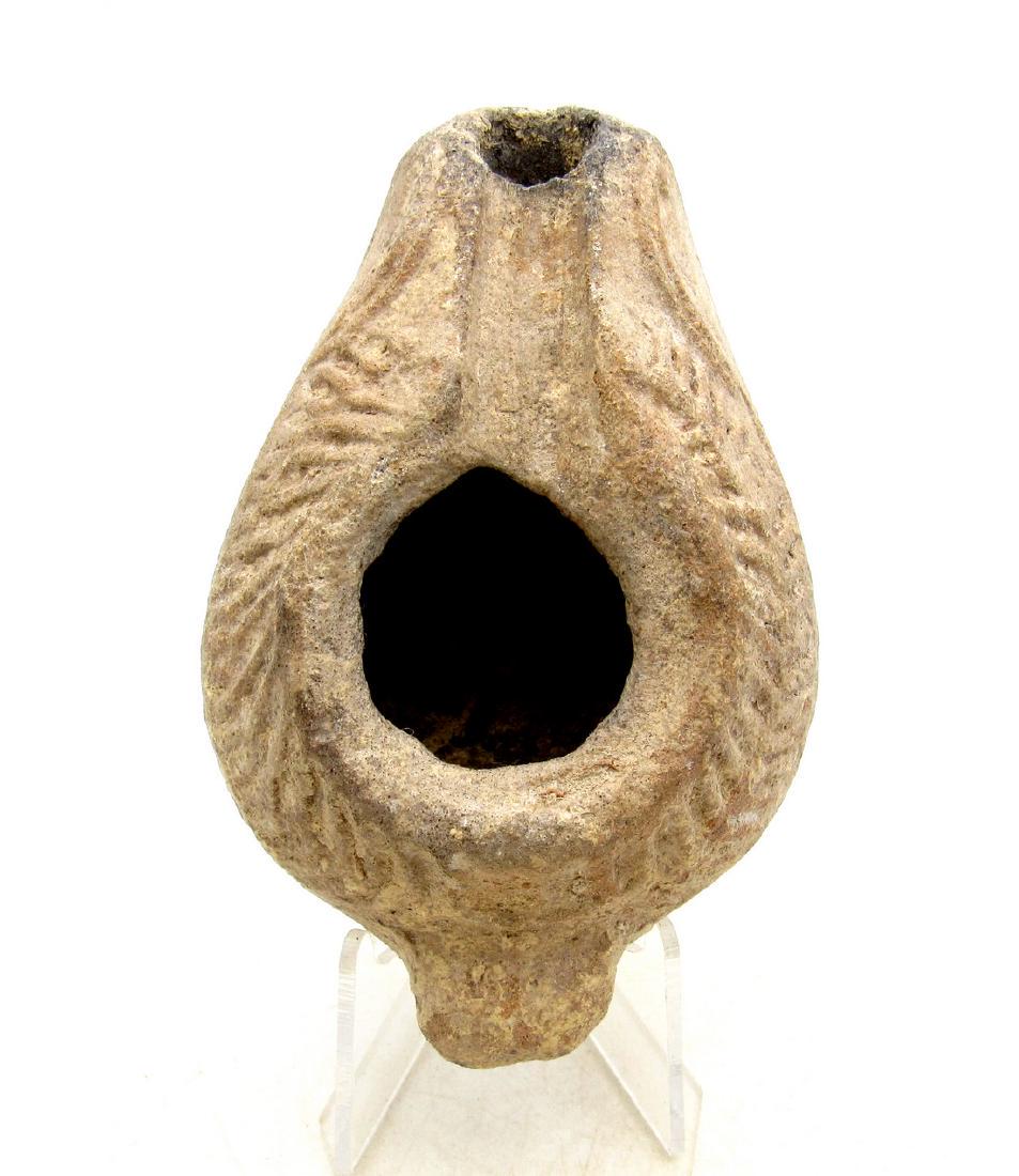 Ancient Byzantine Terracotta Oil Lamp with Laurel: Ancient Byzantine Terracotta Oil Lamp with Laurel Date: C. 330 A.D. Material: terracotta Size: 88mm; 78grams Mould-made unglazed terracotta with impressed laurel wreath decoration. Obtained from an ol