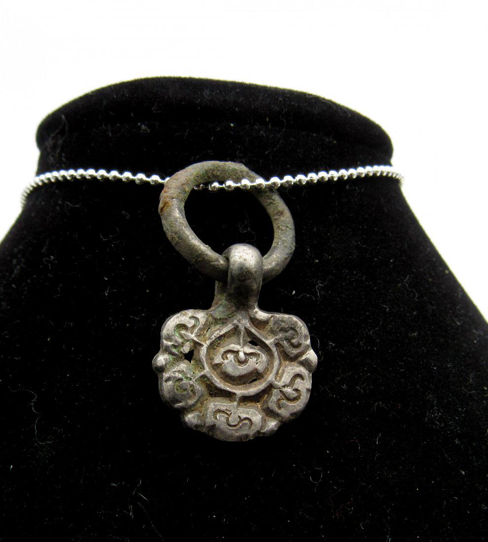Medieval Viking Era Silver Runic Pendant: Medieval Viking Era Silver Runic Pendant Date: ca. 900 AD Material: silver Size: 28mm; 2.1grams Rare Viking Scandinavian Silver Pendant with attached loop; depicting floral pattern in the middle and R