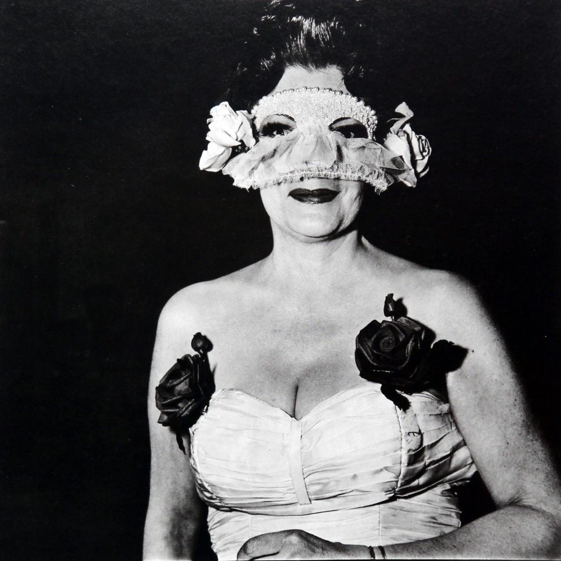 DIANE ARBUS - Lady at masked ball with two roses: Artist: Diane Arbus Title: Lady at masked ball wirh two roses on her dress NY 1967 Date Printed: 1979 Medium: Photogravure Printer Location: Electa Italy Size: 25 x25 cm - 10x 10 inch, Mount Size: 30x
