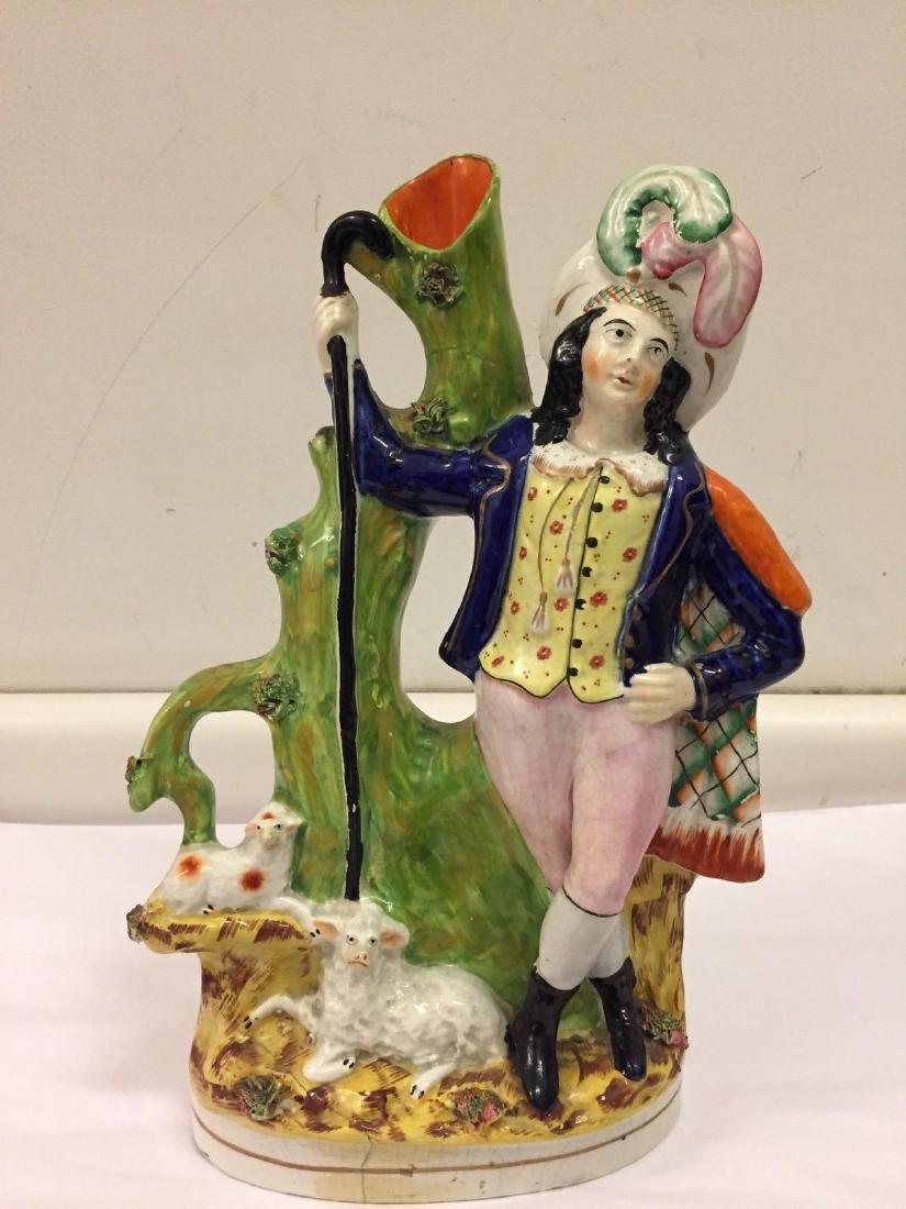Staffordshire Pearlware Spill vase Highlander, ca1890: Antique Staffordshire pearlware spill vase and figure of a Highlander shepherd holding his stick and standing next to two lambs. Dimensions: Height 13", Length 7", Depth 3.5" Condition: restoration to