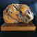 Antique statue Baltic amber rough stone on the wood