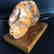Antique statue Baltic amber rough stone on the wood - 2