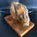Antique statue Baltic amber rough stone on the wood - 3