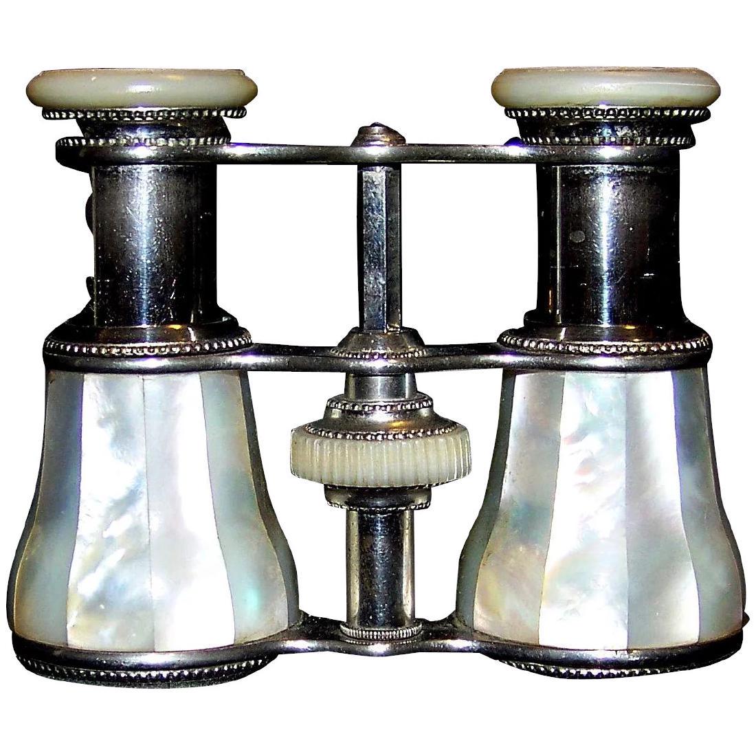 Antique Victorian Inlaid Mother Of Pearl Opera Glasses: Antique Victorian opera glasses constructed with stainless steel and white Mother of Pearl. The first opera glasses were invented in Vienna in 1823 and Mother-Of-Pearl was a popular decoration on many