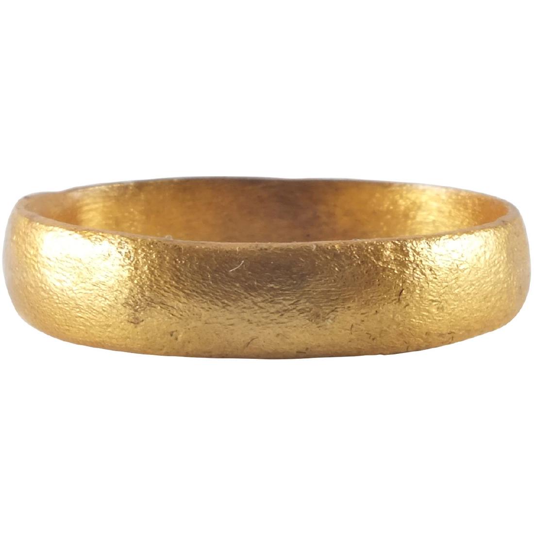 ANCIENT VIKING WEDDING RING C.850-1050 AD: Medium, round faced band. Size 9. 19.2mm inner diameter. Band is 4.3mm wide. Vikings exchanged wedding bands on the pommel of the groom’s sword. Fine patina. Professionally refurbished with the gold
