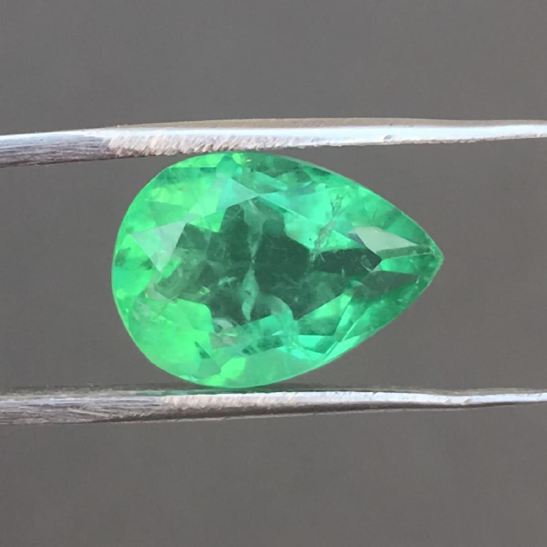 5.70ct. GiE certified Colombian Green emerald: GIE certified Colombian Emerald. Carat Weight: 5.70ct. Color: Green Shape: Pear Cut Measurements: 14.25 x 10.05 x 5.70 mm. Gemstone is comon enhanced by treatment. No Reserve: This lot starts at $1 an