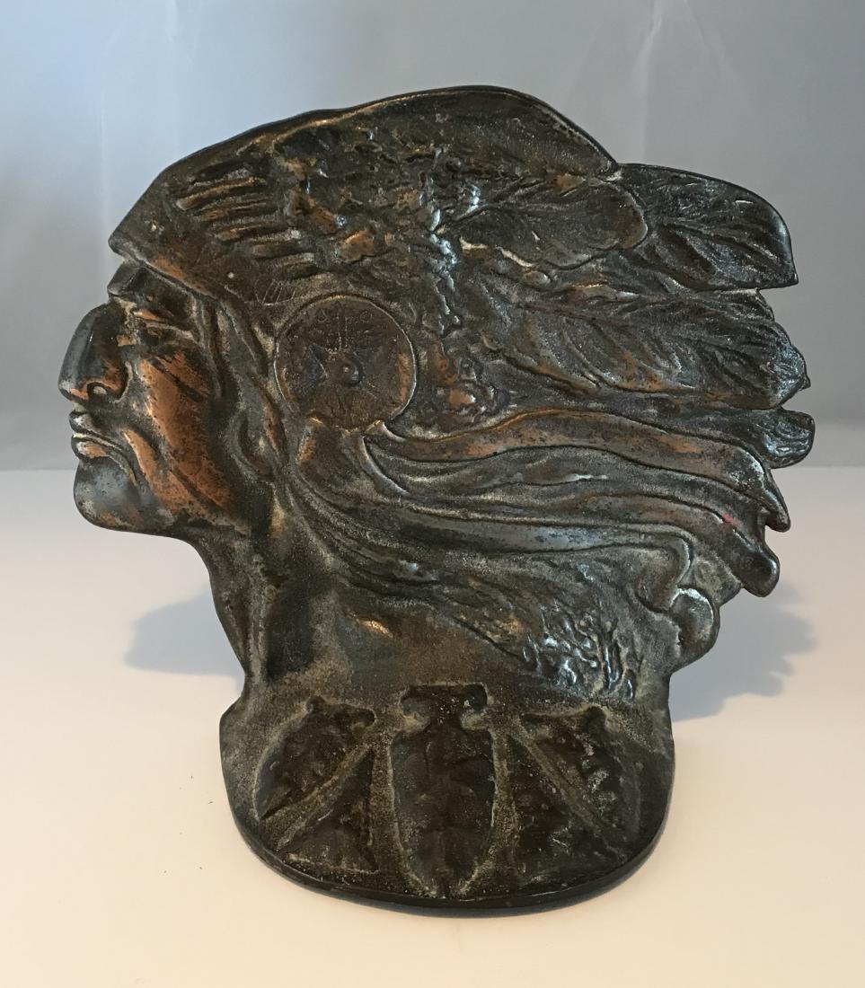 Metal Casting Door Stop: Metal casting Door stop Early 20th c 7.5" wide 6.5"tall Indian in headdress; arrow heads on base; original condition Please note that this lot has a confidential reserve. When you leave a bid in advan