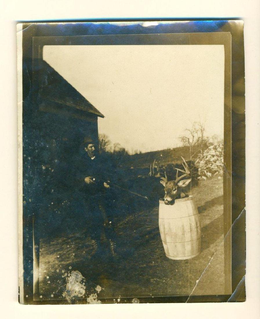 c 1915 BIZARRE HUNTER AIMS RIFLE at TROPHY BUCK DEER: c 1915 BIZARRE HUNTER AIMS RIFLE at TROPHY BUCK DEER HEAD MOUNT IN BARREL, JOKE? c 1915 BIZARRE HUNTER AIMS RIFLE at TROPHY BUCK DEER HEAD MOUNT IN BARREL, JOKE? Circa 1920 Vintage Snapshot Photograph