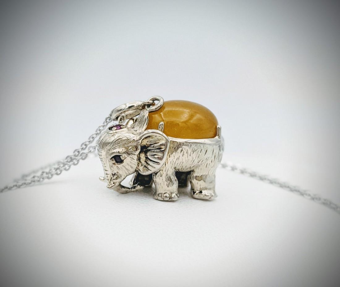 Sterling Silver Necklace and Yellow Jade Elephant: Item: Sterling Silver Necklace and Yellow Jade Elephant Designed Pendant with Rubies Brand: Jean Lin Collection Metal Purity: 925 Sterling Silver Gemstones: Yellow Jade and Rubies Carat Weights: 1 Ova