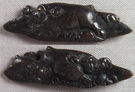 PAIR 19c Japanese sword MENUKI BOARS: Pair of early 19th century Japanese sword menuki depicting wild boars resting on rockery, one with young. Great design and detailing, bronze with dark patina, gold highlights. Length 1 1/2 inches. 