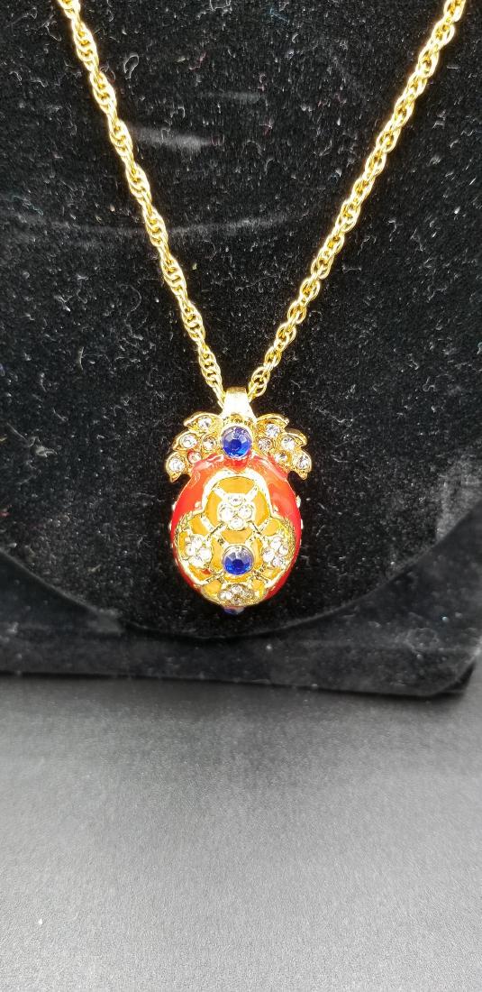 20th Century Fabrage Necklace: Item: 20th Century Fabrage Necklace Origin: Russian Date: 20th Century 1", Excellent Est. Value $125-150. Russian Faberge Egg Pendant with gold crest and 2 1/4 crt shaphire stones; Locket/Necklace 22"