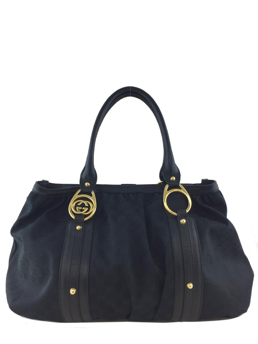 Large Black logo weekender tote with black leather: Large Black logo weekender tote with black leather detail and handles, gold tone hardware. Gucci 17” Lx 12.5” Hx 6” D Handle Drop 8” 5 Gold Feet 1 Snap closure, missing one side snap. Otherwis