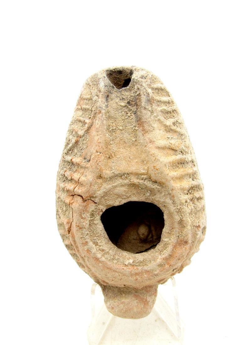 Ancient Roman Terracotta Oil Lamp: Ancient Roman Terracotta Oil Lamp Date: C. 100 - 300 A.D. Scarce Late-Roman /Byzantine Terracotta Oil Lamp with impressed feathering pattern to surface. Complete, original ancient condition. Excellent