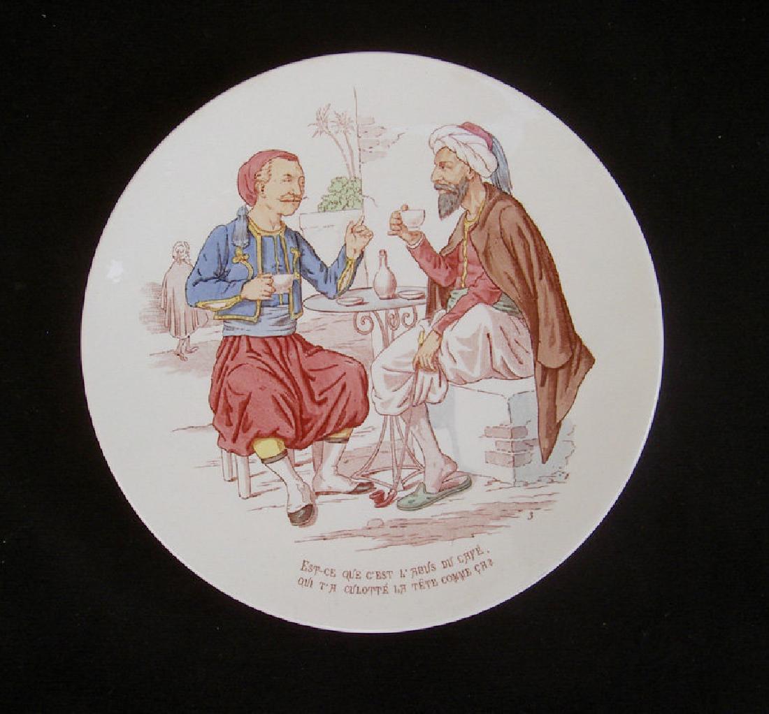 French wall dish with a coffee joke, c 1900: Title: French wall dish with a coffee joke, c 1900 Origin: French Date/Period: : Pre 1920 item #1150106 Materials: Pottery A French Sarreguemines plate, a wall dish. The decoration is of two North Afr