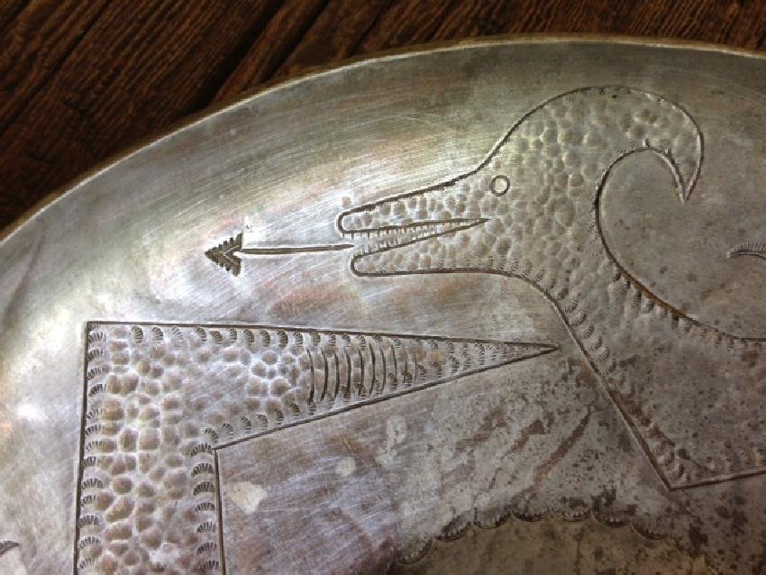 Awa Tsireh Hand-Stamped Metal Bowl with a Water Serpent: This flat-bottomed 8" diameter bowl is hand stamped with two horned water serpents, representing Avanyu, the storm bringer and guardian of water. Extraordinarily detailed, it was made by Awa Tsireh (A