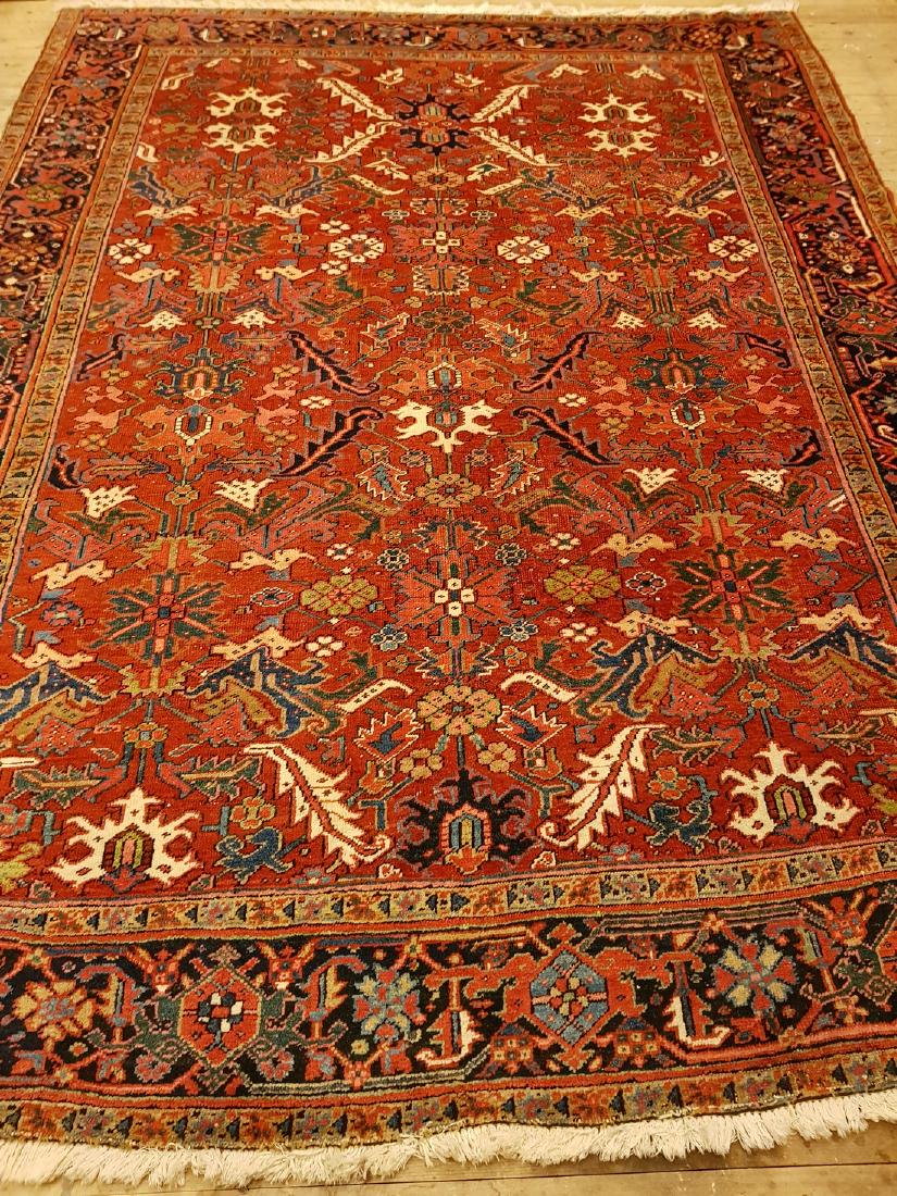 Persian Antique Heriz Rug 9.6x7.4: This carpets is knotted in northwestern Persia. The carpet is often large and very durable and therefore suitable for hallways and public environments. The wool is cut short to an average length, and