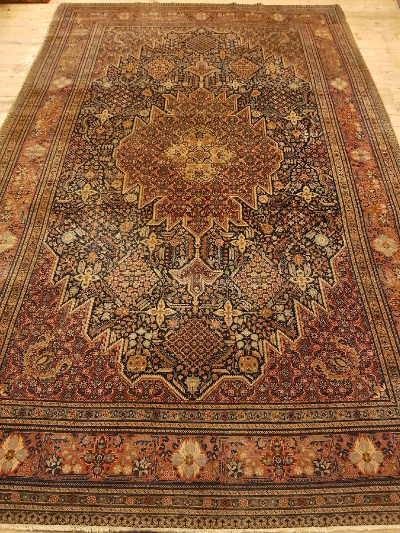 Persian Antique Tabriz Rug 11x7: This carpet is knotted in the city of Tabriz in northwestern Persia. It is a sturdy durable carpet with a short rough pile. The patterns can consist of a centrally placed medallion surrounded by arabe