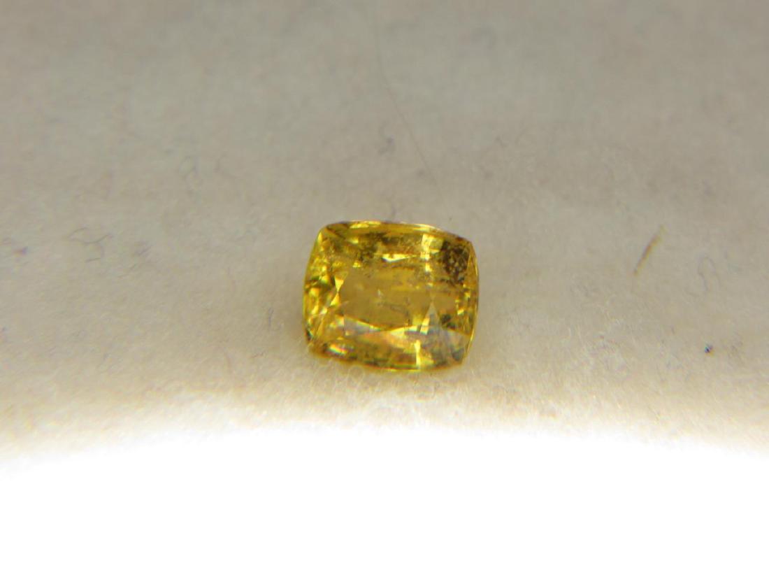 1.78 ct Chondrodite: Pieces: 1 Shape: Oval Faceted Type: Chondrodite Color: Yellow; Under Short Wave SWUV Light only the stone fluoresces to a strong Orange Yellow and Inert under LWUV Weight: 1.78 CT Clarity: VS2-SI