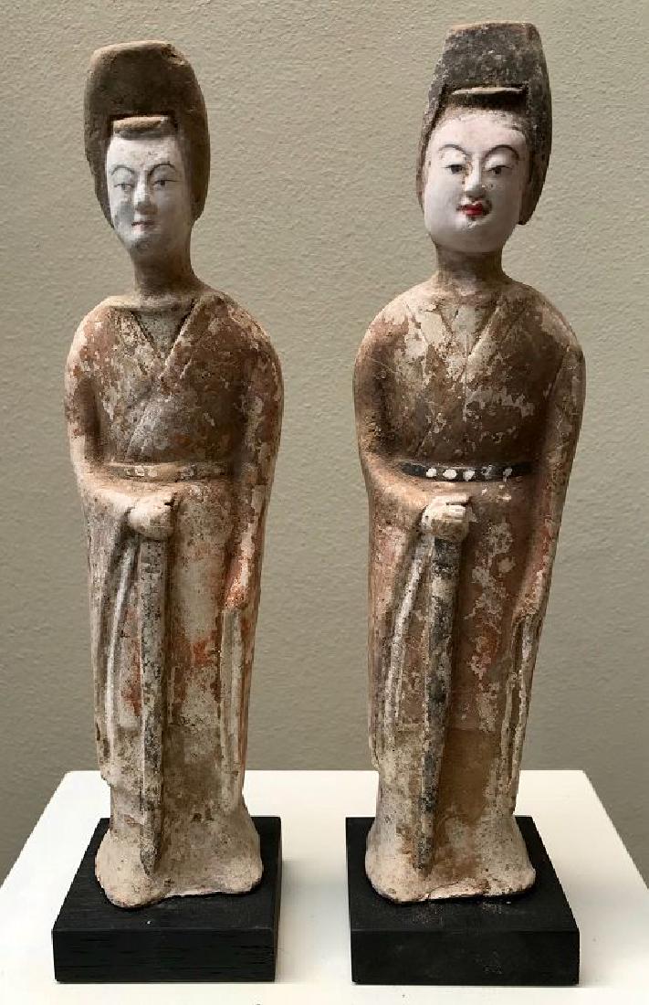 Two Female Warriors Northern Qi (550-577): Two female pottery figures holding swords, both with traces of the original polychromy. Some repainting in the faces. Condition: very good, no visible repairs, although repairs on early pottery are qu