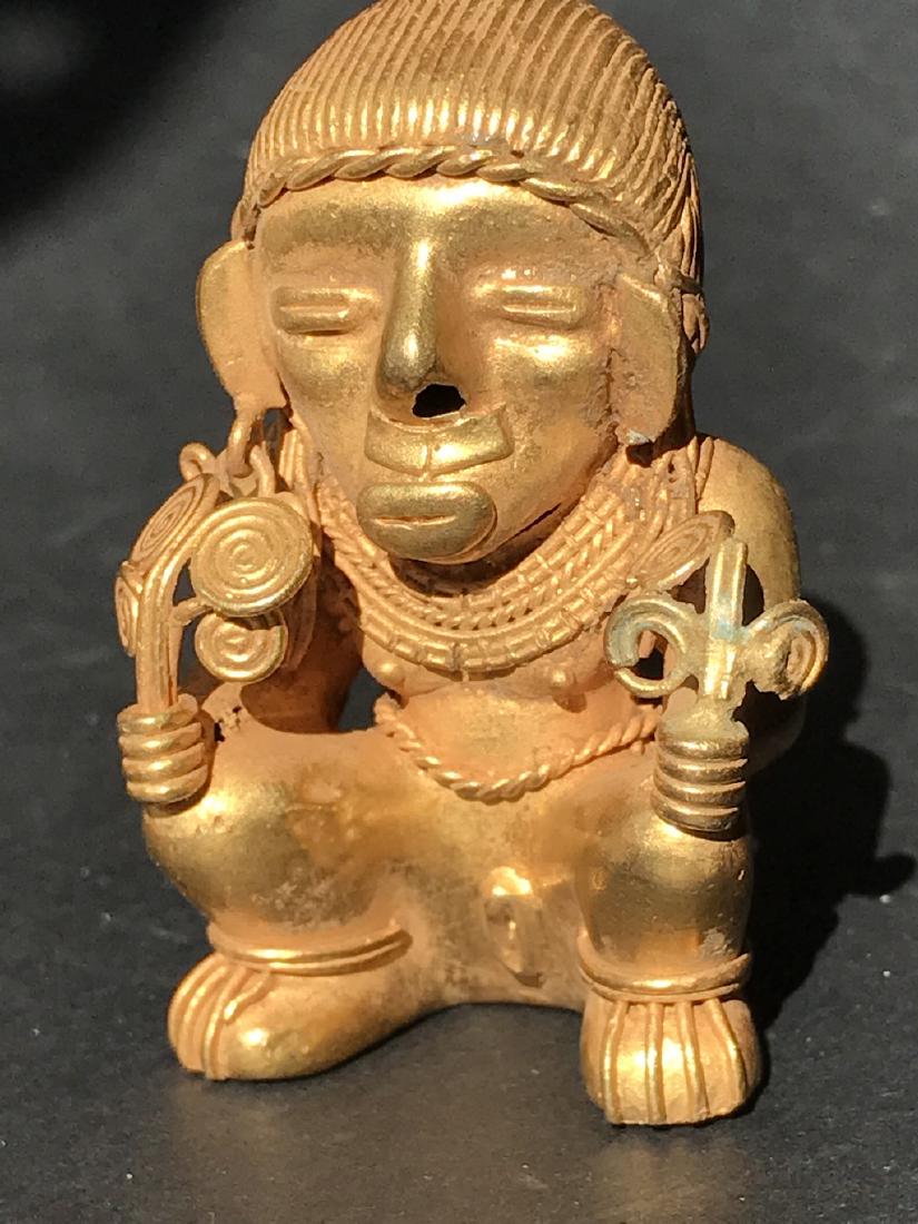 Pre-Columbian art in tumbago. Sitting female figure (1 of 10)