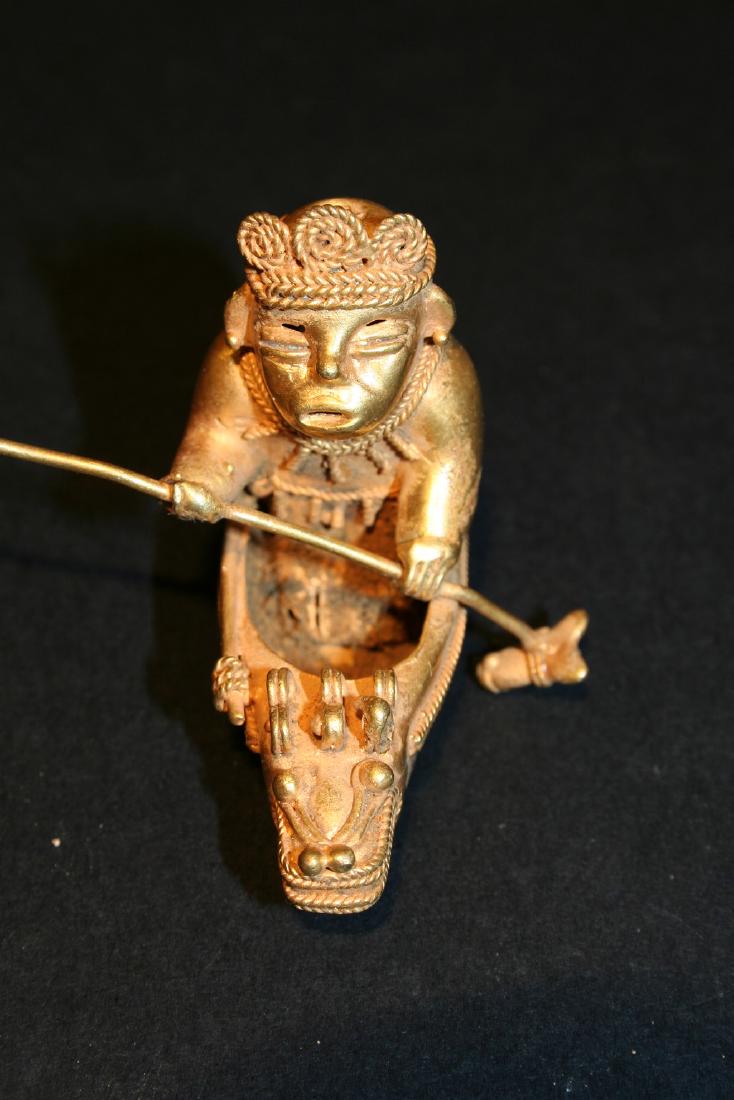 Pre-Columbian art in tumbago. Man adorned intent to row (1 of 9)