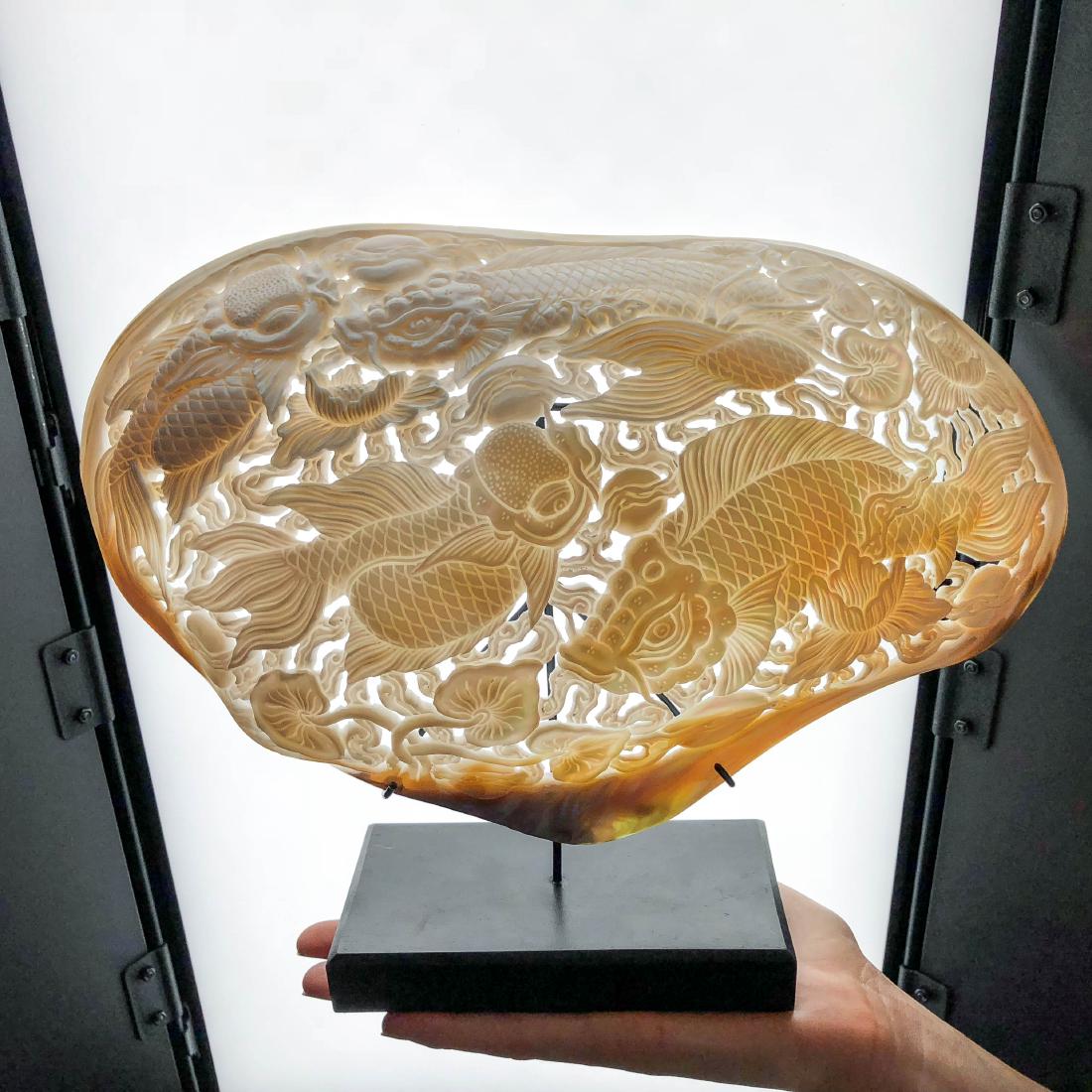 Giant engraved mother of pearl shell - Japanese KOI: Item: Giant engraved mother of pearl shell - Japanese KOI Fish engraving Maker: Design: Jake Richmond Origin: Indonesia Date/Period: 2016 Materials: Shell, WoodHeight including stand 21 cm / 9 inches,