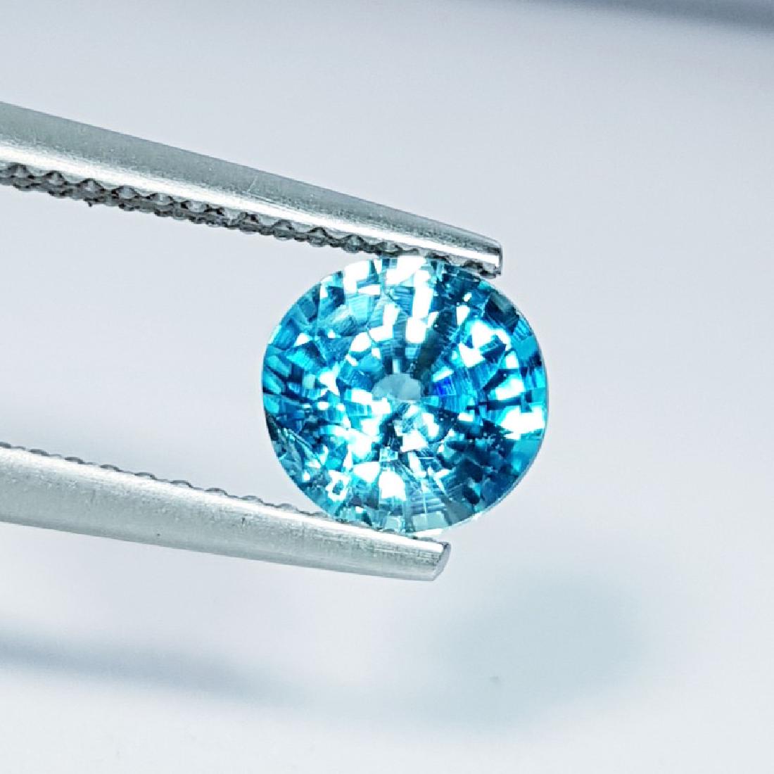 IGI CERTIFIED Natural Blue Zircon - 1.73 ct: Item: "IGI CERTIFIED" Natural Blue Zircon - 1.73 ct Color/Clarity: VS Loose gemstone Carat Weights: 1.73 Size (mm): 6.76 x 6.98 x 4.09 Round - Cambodia No Reserve: This lot starts at $1 and has no res