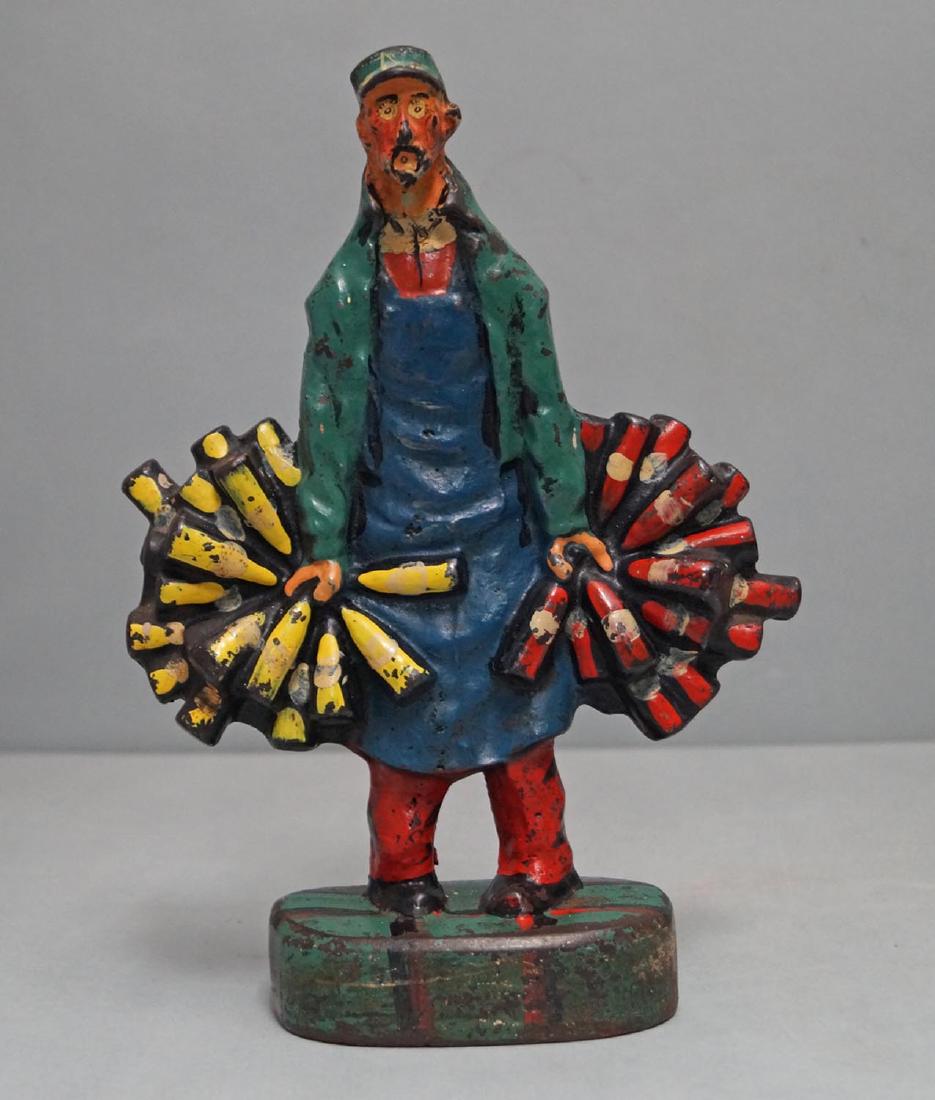 The Wineman Cast Iron Doorstop: The Wineman Cast Iron Doorstop Circa 1915-20’s. 9 ¾" H. x 7" W. Antique cast iron RARE Wineman doorstop done in an unique design with him holding white wine bottles in his right hand & red wine bot