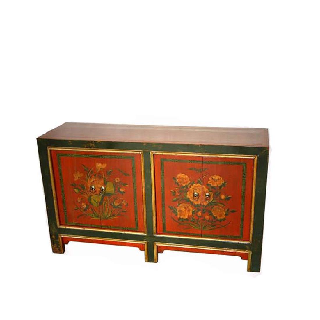 Antique Mongolian Sideboard: New to Jasper52 circa: 1900 Dimensions: L 56 x D 17 x H 33 Red serves as canvas for this beautifully decorated Mongolian chest. The floral motif is highlighted as it is centered on each set of cupboar