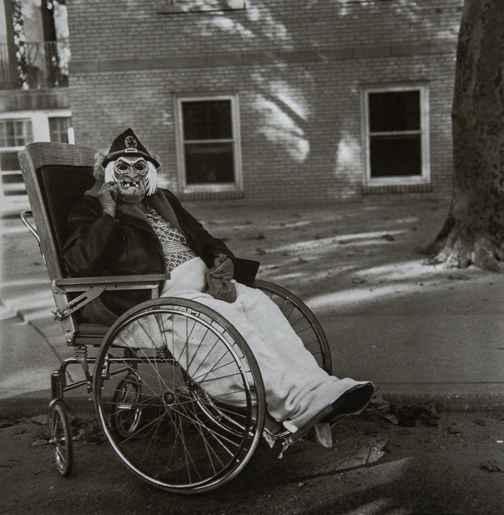 DIANE ARBUS - Masked Woman in Wheelchair: Artist: Diane Arbus Title: Masked Woman in Wheelchair Medium: Photo Litho, 1995, Italy Dimensions: 9.5x9.5" Heat Wax Mounted on 12x16" Conservation Board Diane Arbus was an American photographer often